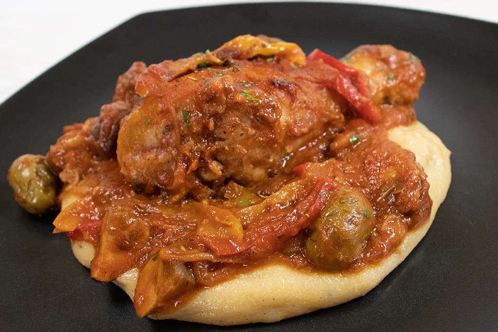 Sauced Chicken on a black plate.